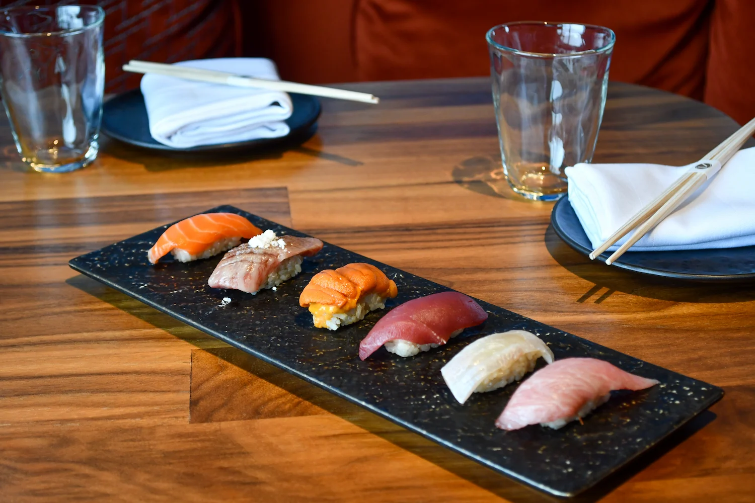 Nigiri arranged on a black serving plate at The Naisho Room
