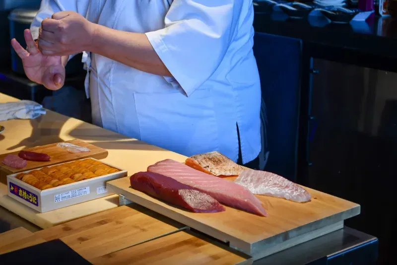 Chef preparing sushi ingredients at The Naisho Room