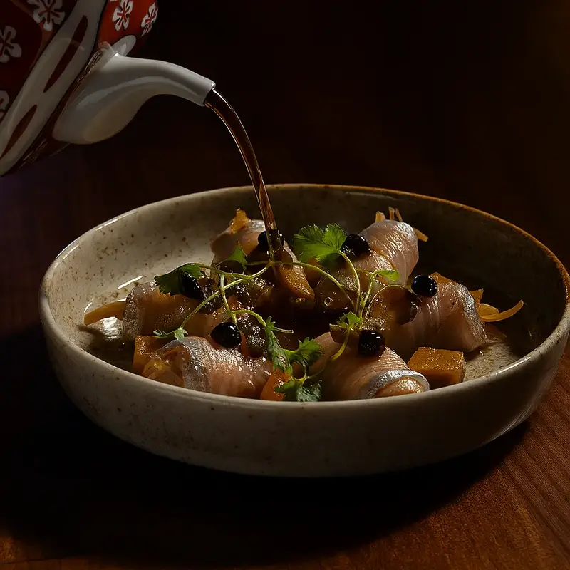Warm broth poured over a plated dish at The Naisho Room